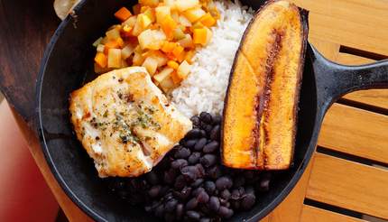 Traditional Costa Rican Casado meal with rice, beans, plantains and fish