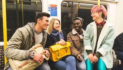 Friends travel by tube in London